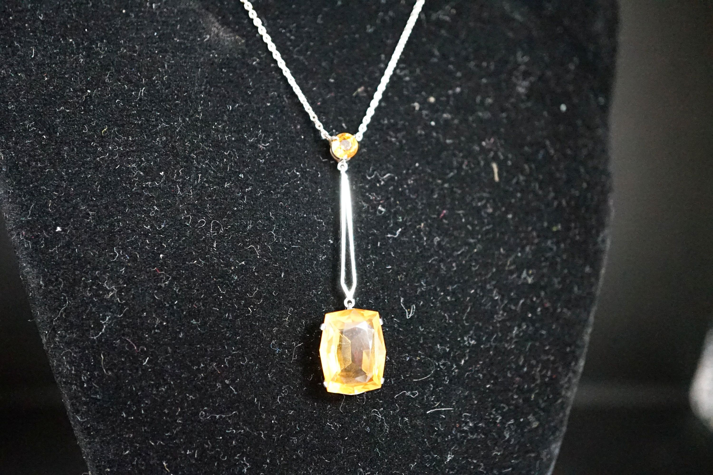 A white metal and two stone citrine set drop line pendant necklace, pendant 45mm, chain 40cm, gross weight 4.1 grams.